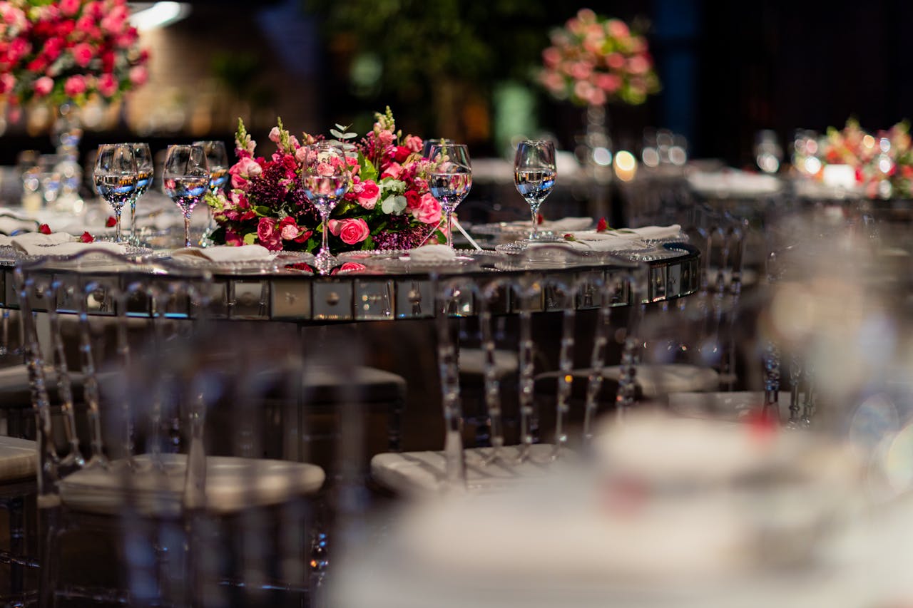 Luxurious wedding reception table setup with pink floral centerpiece and glassware.