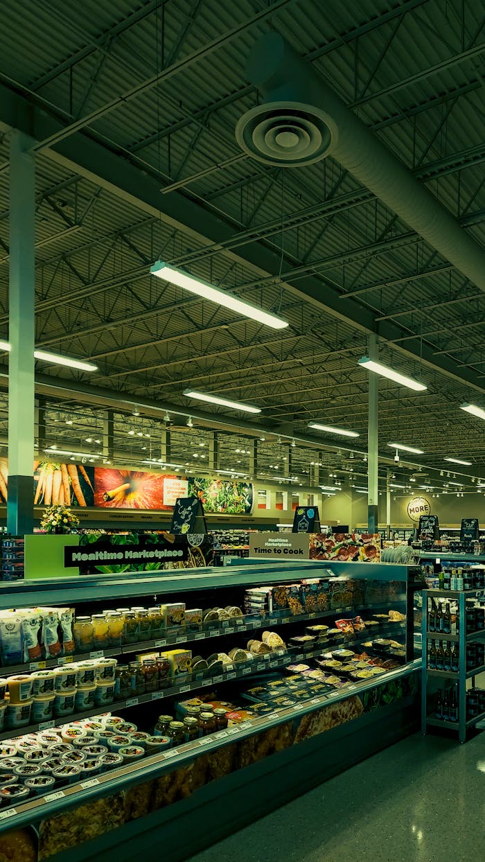 Colorful grocery store aisle with a variety of products on display under bright lighting.